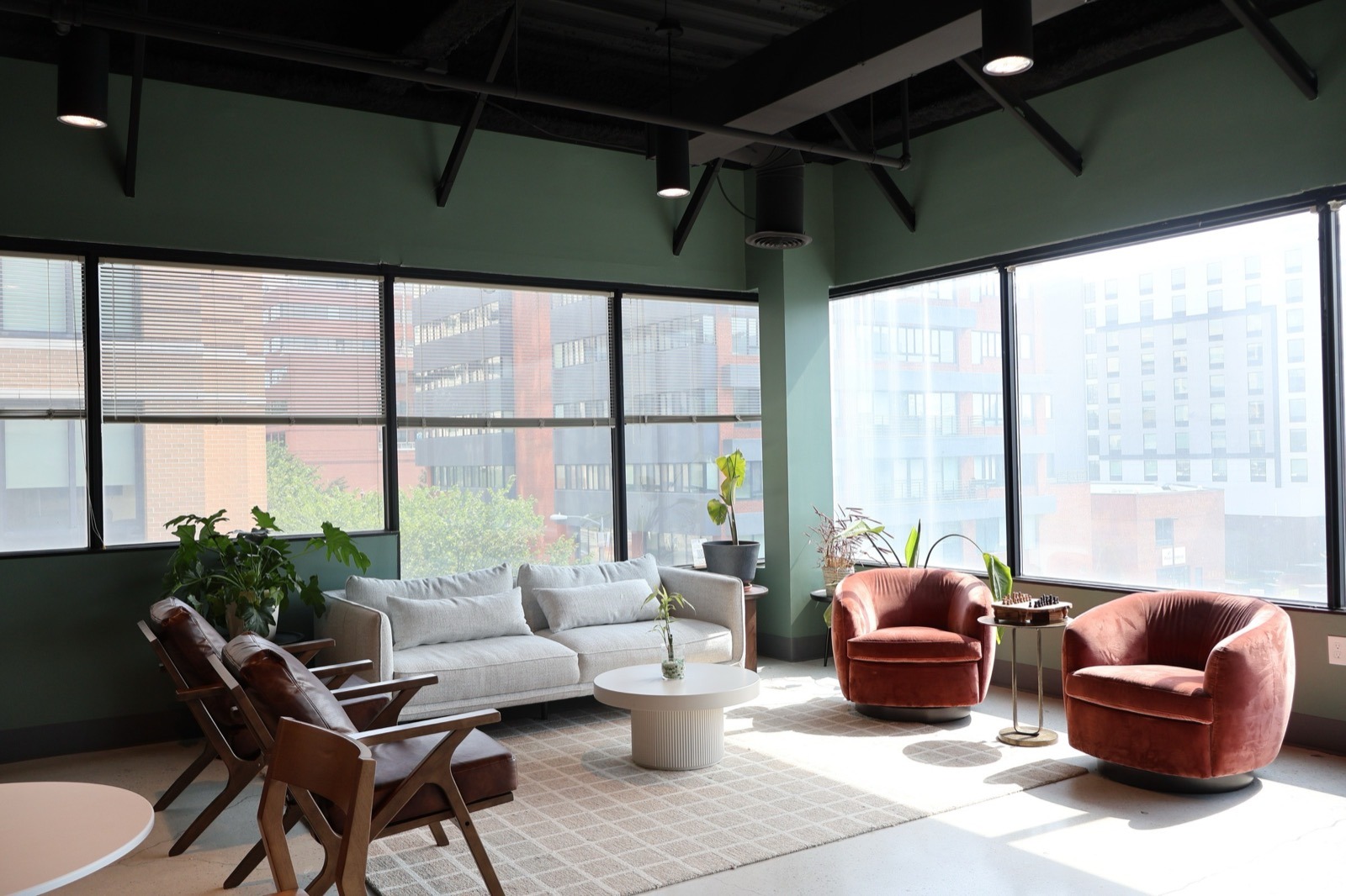 A shared lounge with leather and velvet chairs