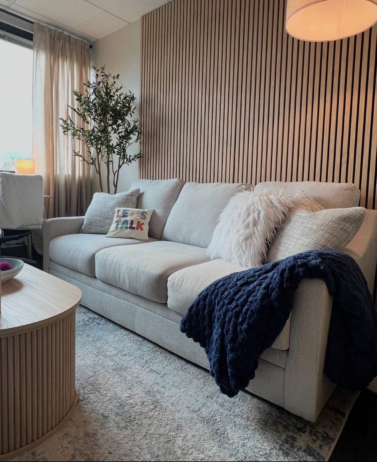 A warm corner of the Our Place Towson office with our 'Let's Talk' couch
